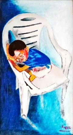 A baby sleeping on a plastic chair